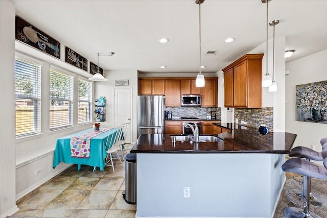 2506 Solitude, Deer Park, TX 77536 - kitchen with stainless steel appliances, a sink, brown cabinets, dark countertops, and tasteful backsplash