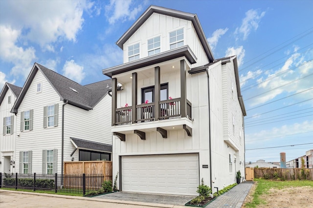 1008 Golden Nectar, Houston, TX 77008 - view of front of property featuring board and batten siding, a balcony, a garage, and driveway