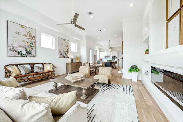 1008 Golden Nectar, Houston, TX 77008 - living room with ceiling fan, a glass covered fireplace, recessed lighting, light wood-style floors, and built in features
