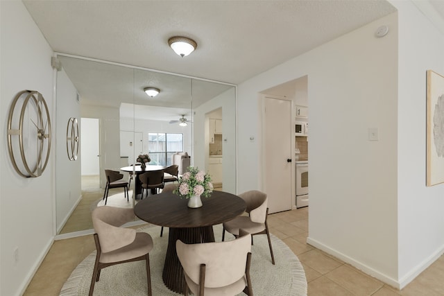 1100 Augusta Dr Unit 33, Houston, TX 77057 - dining room featuring ceiling fan, baseboards, and light tile patterned floors