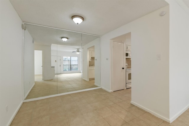 1100 Augusta Dr Unit 33, Houston, TX 77057 - hall featuring light tile patterned flooring and baseboards
