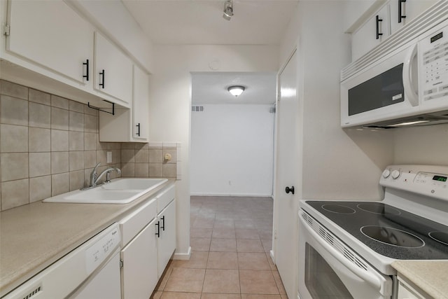 1100 Augusta Dr Unit 33, Houston, TX 77057 - kitchen with white appliances, a sink, decorative backsplash, light countertops, and light tile patterned floors