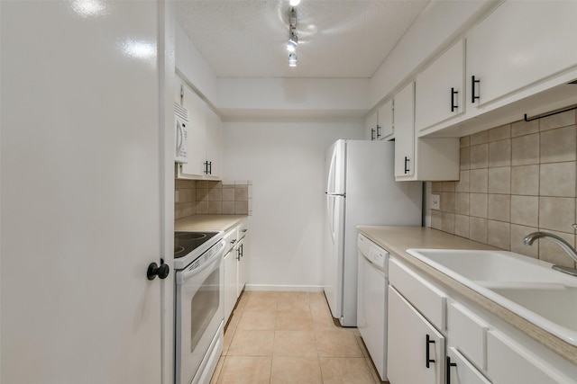 1100 Augusta Dr Unit 33, Houston, TX 77057 - kitchen with white appliances, backsplash, white cabinets, and light countertops