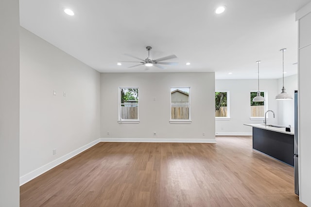 4224 Buck St, Houston, TX 77020 - unfurnished living room with a ceiling fan, healthy amount of natural light, light wood-style flooring, baseboards, and recessed lighting
