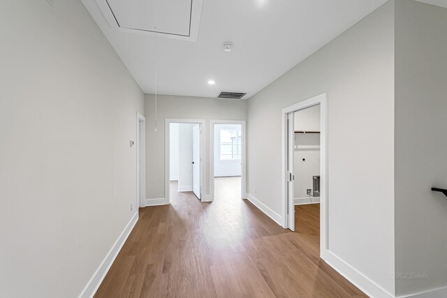 4224 Buck St, Houston, TX 77020 - hallway featuring attic access, wood finished floors, baseboards, and recessed lighting