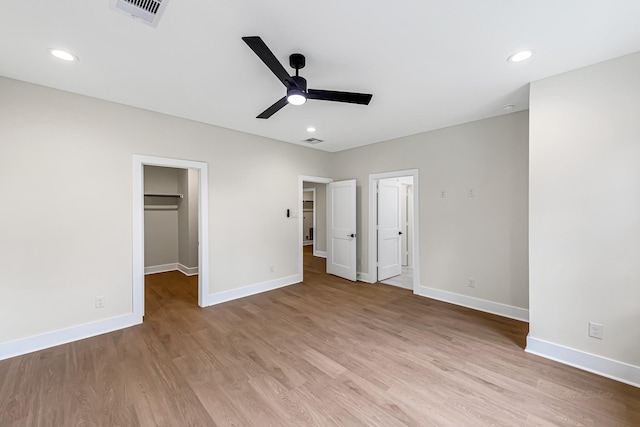 4224 Buck St, Houston, TX 77020 - unfurnished bedroom featuring baseboards, light wood-style floors, a walk in closet, ceiling fan, and recessed lighting