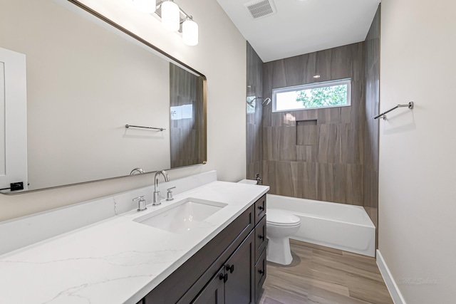 4224 Buck St, Houston, TX 77020 - bathroom with vanity, toilet, shower / bathtub combination, and wood finished floors