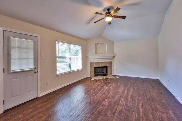 19511 Ingham Dr, Katy, TX 77449 - unfurnished living room featuring vaulted ceiling, a ceiling fan, a tile fireplace, wood finished floors, and baseboards