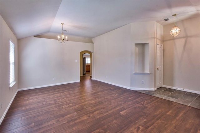19511 Ingham Dr, Katy, TX 77449 - unfurnished room featuring a chandelier, arched walkways, dark wood-style floors, lofted ceiling, and baseboards