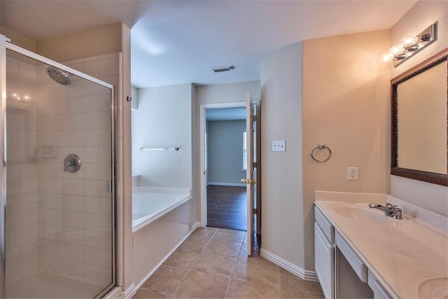 19511 Ingham Dr, Katy, TX 77449 - bathroom with a shower stall, baseboards, double vanity, and a bath