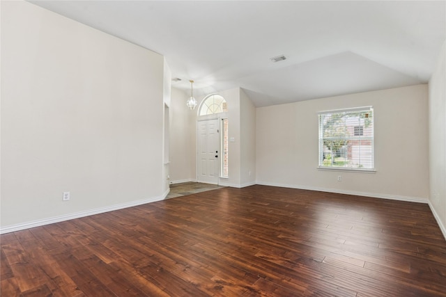 19511 Ingham Dr, Katy, TX 77449 - unfurnished living room with a chandelier, vaulted ceiling, and dark wood-type flooring