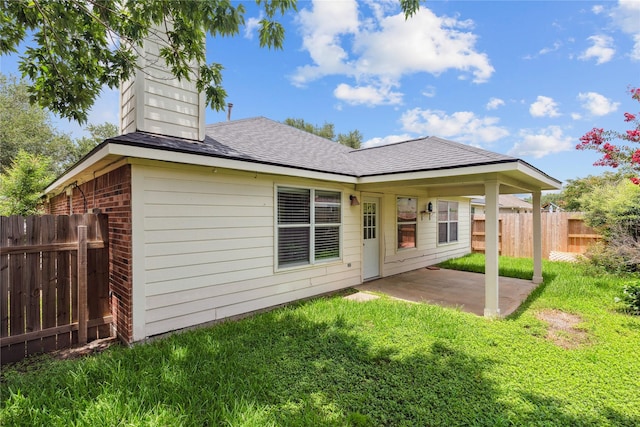 19511 Ingham Dr, Katy, TX 77449 - back of property with a patio, brick siding, and a shingled roof