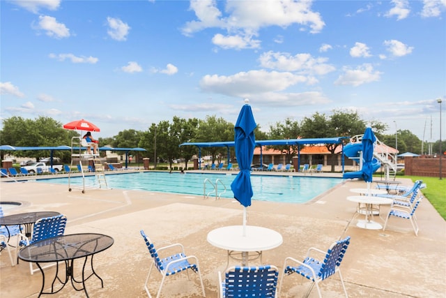 19511 Ingham Dr, Katy, TX 77449 - community pool featuring a water slide and a patio area