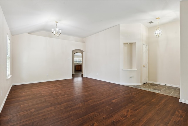 19511 Ingham Dr, Katy, TX 77449 - spare room with a chandelier, arched walkways, wood finished floors, vaulted ceiling, and plenty of natural light