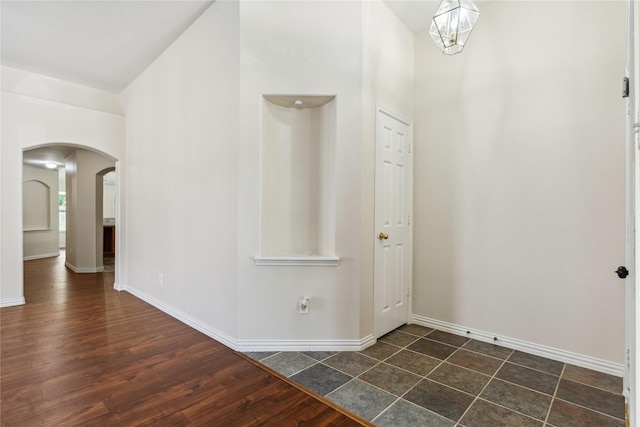 19511 Ingham Dr, Katy, TX 77449 - entrance foyer with arched walkways, a towering ceiling, and dark wood-style floors