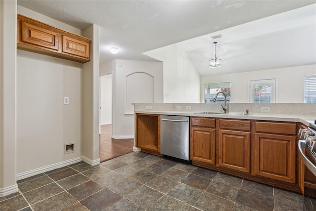 19511 Ingham Dr, Katy, TX 77449 - kitchen featuring stainless steel appliances, brown cabinets, light countertops, hanging light fixtures, and dark stone finish floors
