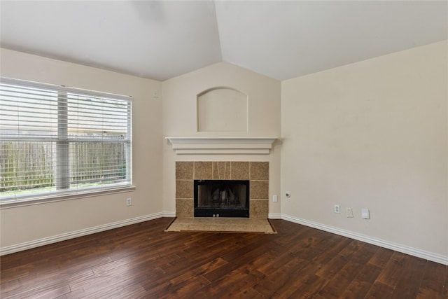 19511 Ingham Dr, Katy, TX 77449 - unfurnished living room featuring vaulted ceiling, wood finished floors, and a tiled fireplace
