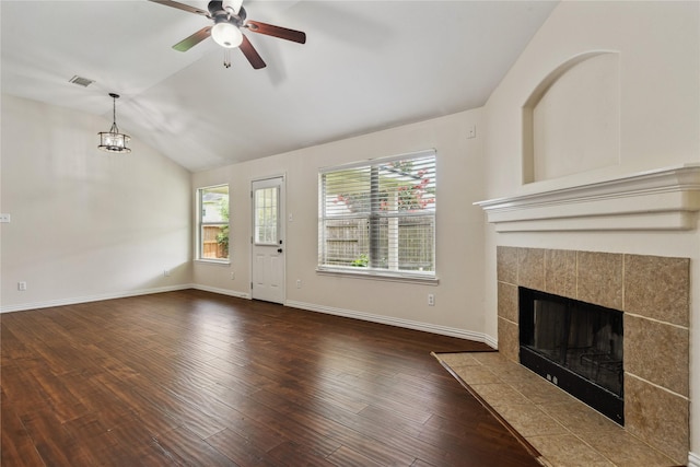 19511 Ingham Dr, Katy, TX 77449 - unfurnished living room featuring vaulted ceiling, a ceiling fan, a fireplace, wood finished floors, and a chandelier