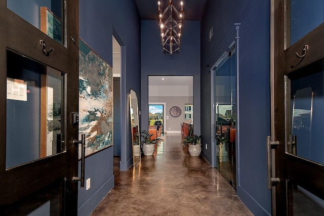 12595 St Louis Ct, Willis, TX 77318 - foyer entrance featuring a high ceiling, finished concrete floors, baseboards, and arched walkways