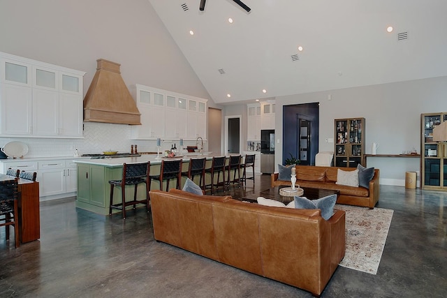 12595 St Louis Ct, Willis, TX 77318 - living area featuring concrete floors, high vaulted ceiling, a ceiling fan, and recessed lighting