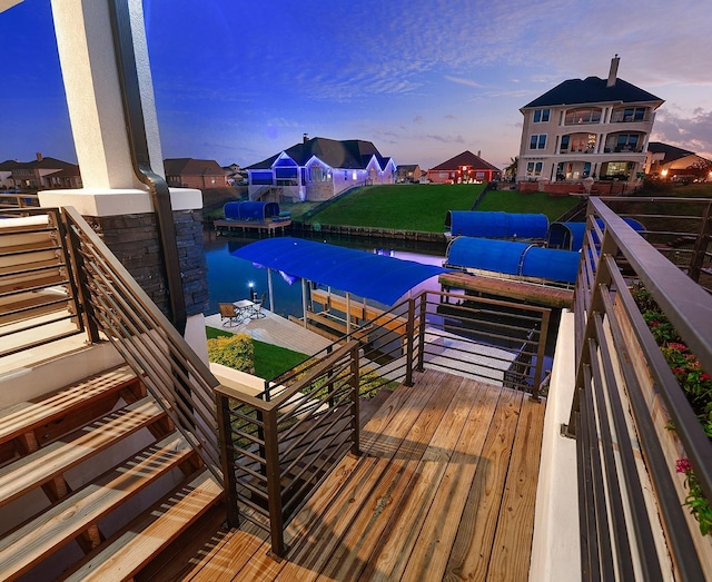 12595 St Louis Ct, Willis, TX 77318 - pool at dusk featuring a boat dock, boat lift, a lawn, and a water view