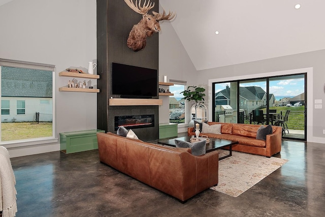 12595 St Louis Ct, Willis, TX 77318 - living area featuring finished concrete floors, high vaulted ceiling, a glass covered fireplace, recessed lighting, and baseboards