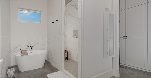 12595 St Louis Ct, Willis, TX 77318 - bathroom featuring a freestanding tub, tiled shower, concrete flooring, and a wainscoted wall
