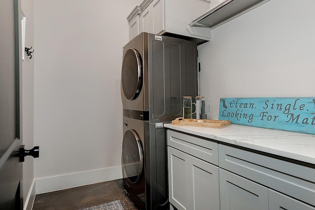 12595 St Louis Ct, Willis, TX 77318 - laundry area with stacked washing machine and dryer, baseboards, and cabinet space