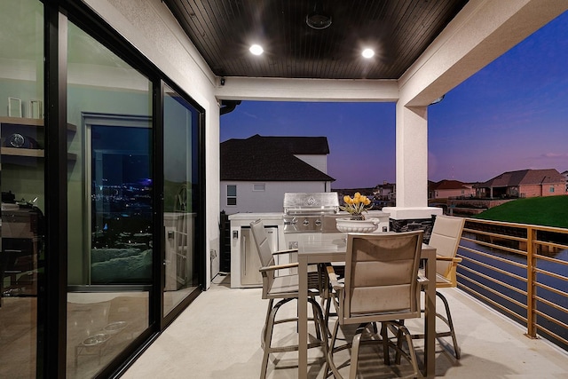 12595 St Louis Ct, Willis, TX 77318 - patio terrace at dusk with a grill and outdoor dining area