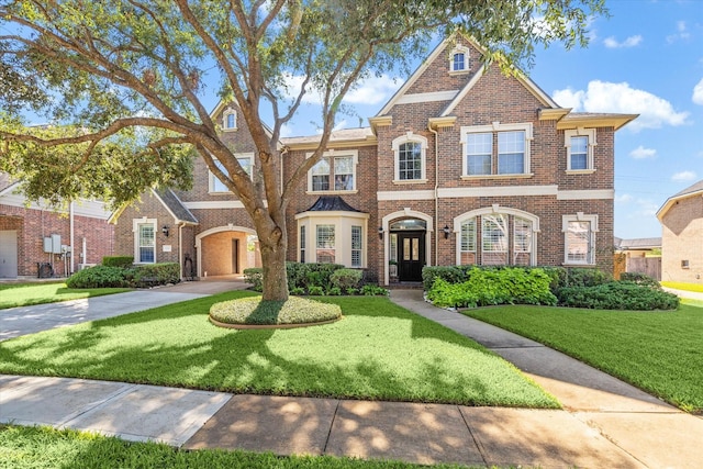8718 Stowe Creek Ln, Missouri City, TX 77459 - view of front of property with brick siding and a front lawn