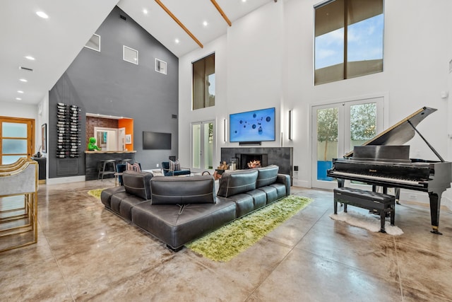 4102 Coleridge, West University Place, TX 77005 - living room with a high ceiling, concrete flooring, a lit fireplace, healthy amount of natural light, and recessed lighting