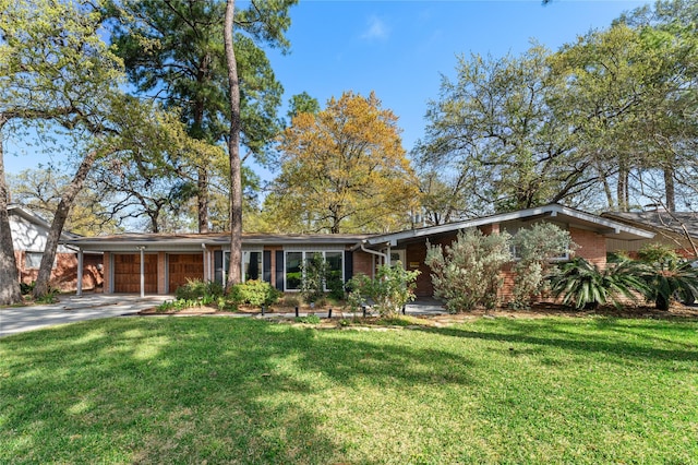 10134 Hanka Dr, Houston, TX 77043 - mid-century home featuring a garage, driveway, a front yard, and brick siding