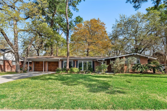 10134 Hanka Dr, Houston, TX 77043 - view of front facade with a garage, brick siding, driveway, and a front yard