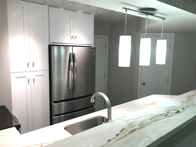 17202 Imperial Valley Dr Unit 16, Houston, TX 77060 - kitchen with freestanding refrigerator, a sink, white cabinetry, and black electric range oven