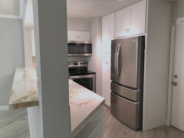 17202 Imperial Valley Dr Unit 16, Houston, TX 77060 - kitchen with stainless steel appliances, light stone countertops, and white cabinetry