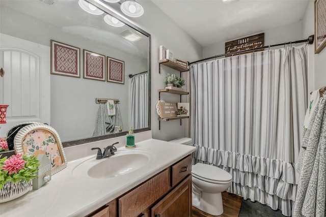 911 Dove Run Trl, College Station, TX 77845 - bathroom featuring toilet, vanity, and wood finished floors