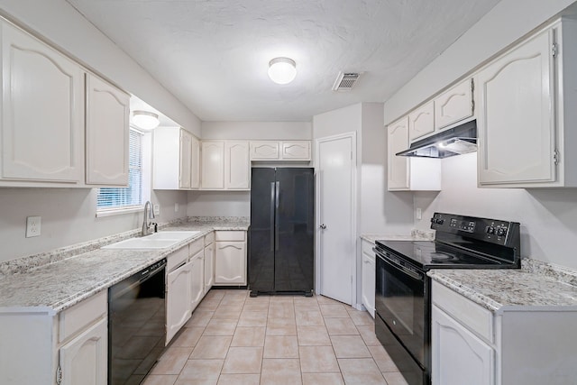 8006 Barnhill Dr, Humble, TX 77338 - kitchen featuring black appliances, under cabinet range hood, a sink, light tile patterned floors, and white cabinetry