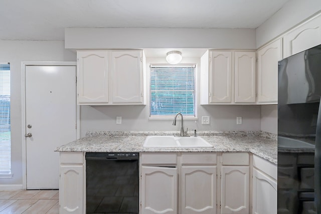 8006 Barnhill Dr, Humble, TX 77338 - kitchen featuring black appliances, a sink, light countertops, white cabinets, and light tile patterned floors