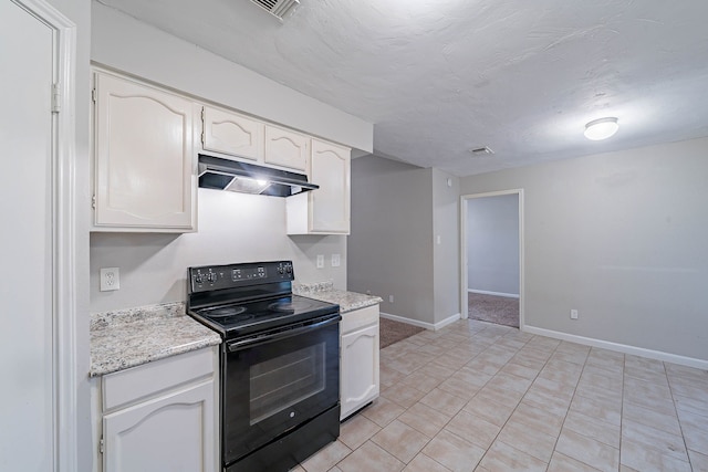 8006 Barnhill Dr, Humble, TX 77338 - kitchen with black range with electric stovetop, under cabinet range hood, white cabinets, and baseboards