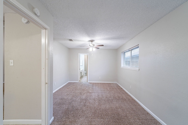 8006 Barnhill Dr, Humble, TX 77338 - empty room with ceiling fan, carpet, a textured ceiling, a smoke detector, and baseboards