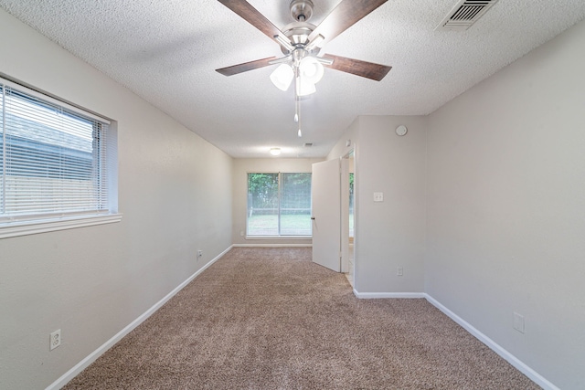 8006 Barnhill Dr, Humble, TX 77338 - carpeted spare room with a textured ceiling, ceiling fan, and baseboards