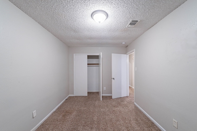 8006 Barnhill Dr, Humble, TX 77338 - unfurnished bedroom with a textured ceiling, carpet flooring, a closet, and baseboards