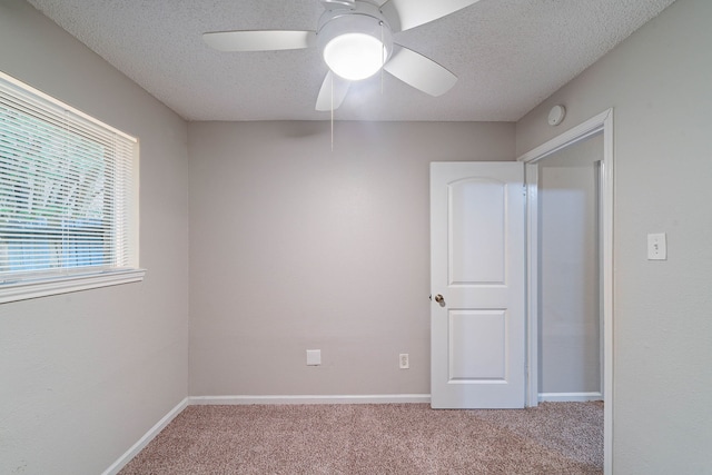 8006 Barnhill Dr, Humble, TX 77338 - unfurnished bedroom with carpet flooring, a textured ceiling, ceiling fan, and baseboards