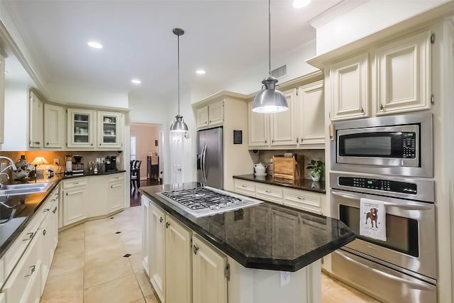 602 Rock Cv, Houston, TX 77079 - kitchen with stainless steel appliances, a warming drawer, a sink, backsplash, and light tile patterned floors