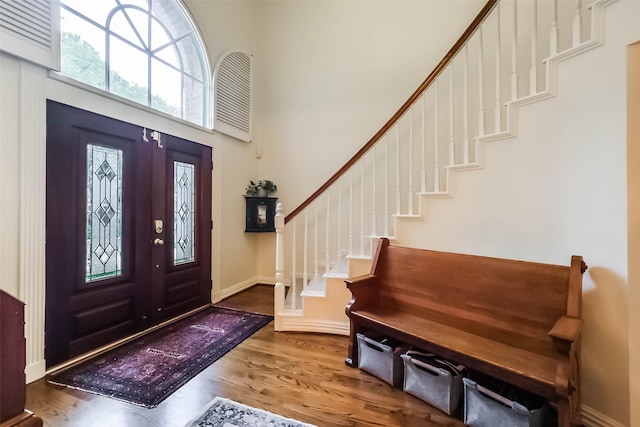602 Rock Cv, Houston, TX 77079 - foyer entrance featuring wood finished floors, stairway, a towering ceiling, and baseboards