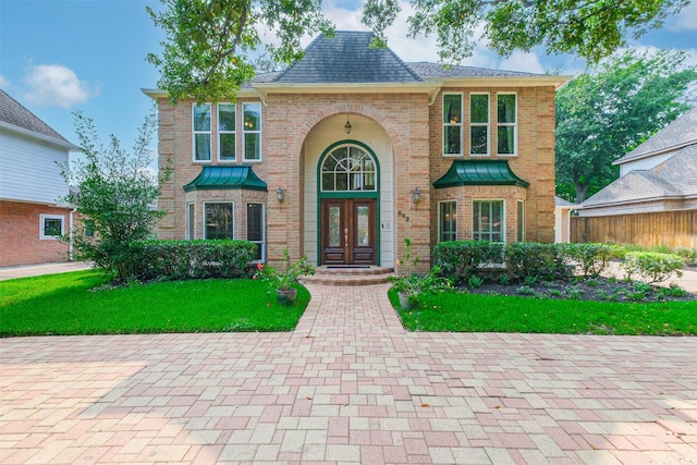 602 Rock Cv, Houston, TX 77079 - view of front of property featuring brick siding, a front yard, and french doors
