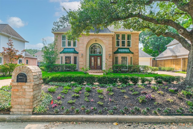 602 Rock Cv, Houston, TX 77079 - traditional-style home featuring french doors and brick siding
