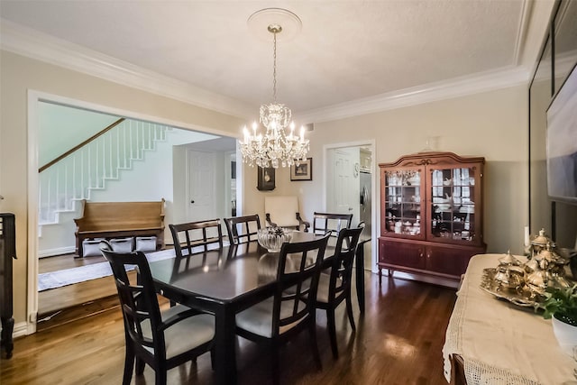 602 Rock Cv, Houston, TX 77079 - dining space with stairway, dark wood finished floors, a chandelier, and ornamental molding