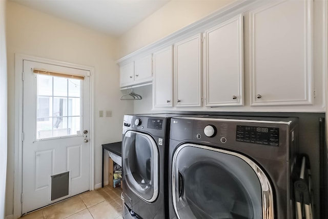 602 Rock Cv, Houston, TX 77079 - washroom with washer and clothes dryer, cabinet space, and light tile patterned floors