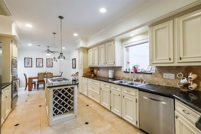 602 Rock Cv, Houston, TX 77079 - kitchen featuring appliances with stainless steel finishes, cream cabinets, a sink, dark countertops, and recessed lighting